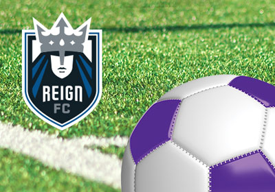 Turf field closeup with purple and white soccer ball and ReignFC logo