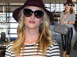 Legs made for leather! Rosie Huntington-Whiteley makes the airport her catwalk as she struts around in VERY tight trousers 
