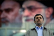Iran's President Mahmoud Ahmadinejad stands beneath a portrait of Supreme Leader Ayatollah Ali Khamenei.