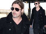 'We have a very normal, very grounded home': Brad Pitt takes solo flight at LAX...as Angelina Jolie opens up about their family