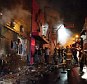 Appaliling loss of life: Firefighters work to douse a fire at the Kiss Club in Santa Maria city, Rio Grande do Sul state, Brazil, where hundreds of people died 