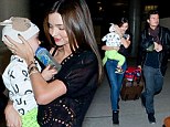Orlando Broom and Miranda Kerr play the perfect parents as they arrive at Los Angeles International Airport with son Flynn on Saturday