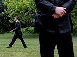 Embarrassment: U.S. President Barack Obama walks across the South Lawn of the White House, behind a Secret Service agent, in Washington DC, on Wednesday