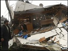 Hamas member surveys damage to offices of PM Ismail Haniya 31 Dec