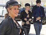 Barca-loner! Gerard Pique carries the baby as he bids Shakira farewell at the airport in Spain