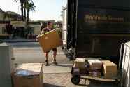 In this March 6, 2012 photo, a UPS worker loads packages in Los Angeles