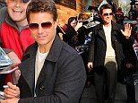 Army of fans: Tom Cruise took time to sign autographs and pose for snaps as he visited The Daily Show with Jon Stewart in New York, on Tuesday