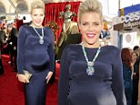 Heavily pregnant Busy Philipps shows off every curve in bewitching black gown on the SAG Awards red carpet 