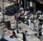 Investigators in haz-mat suits examine the scene of the second bombing today as they try to piece together fragments of the bomb