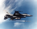 F-16 aircraft in flight firing a AIM-120 AMRAAM missile