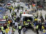 Emergency response: Medical workers aid injured people at the finish line of the 2013 Boston Marathon following an explosion in Boston on Monday afternoon. Police and fire services swarmed the scene