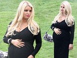 Quite revealing: Pregnant Jessica Simpson wore a plunging black gown to her friend's wedding on Saturday in the Pacific Palisades, California