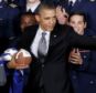 Playing ball: President Obama told a reporter that he would have to think twice about letting his son play football