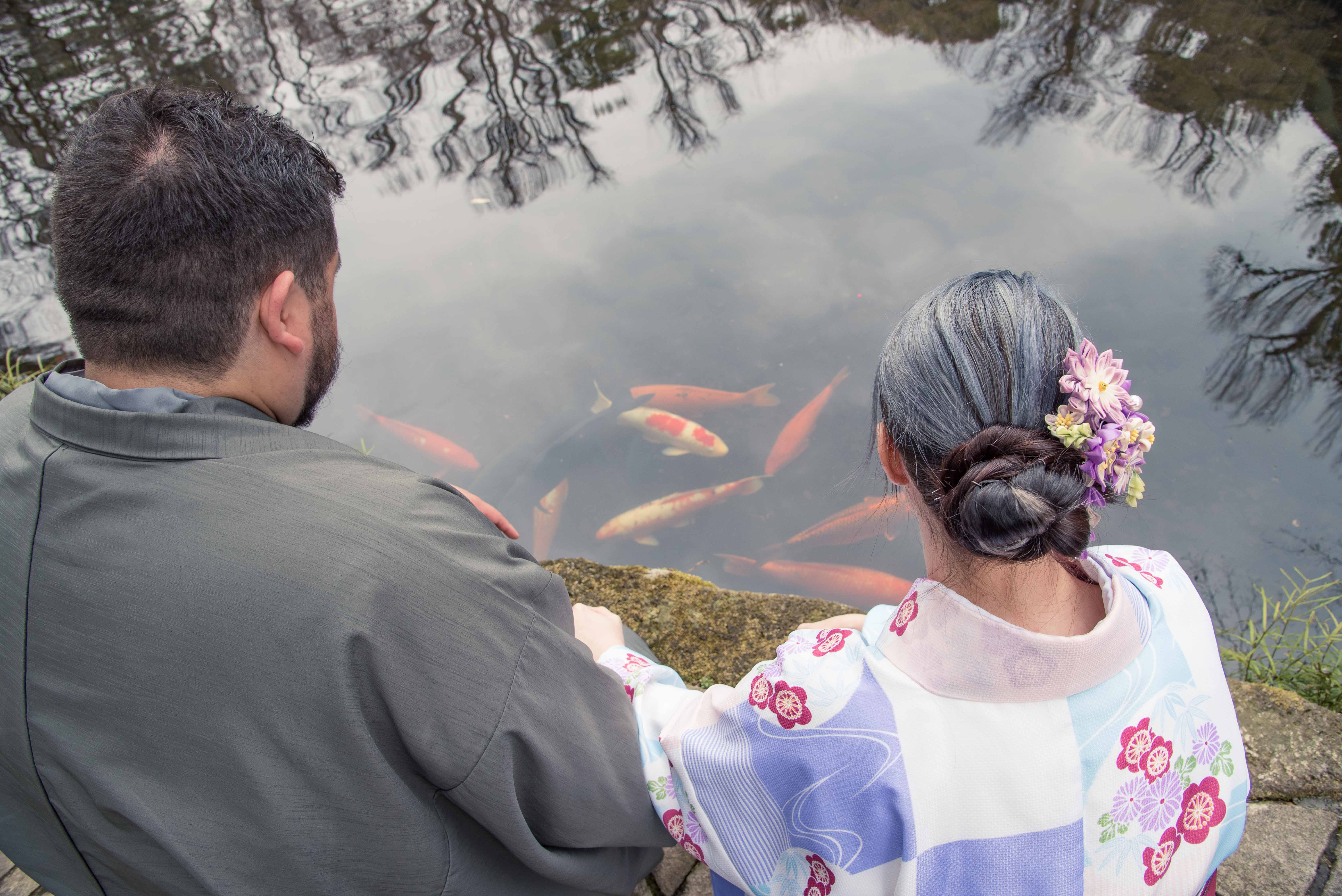 Kimono clad couple enjoy the Koi Carp