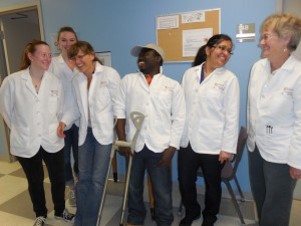 Researchers standing in a line in white lab coats