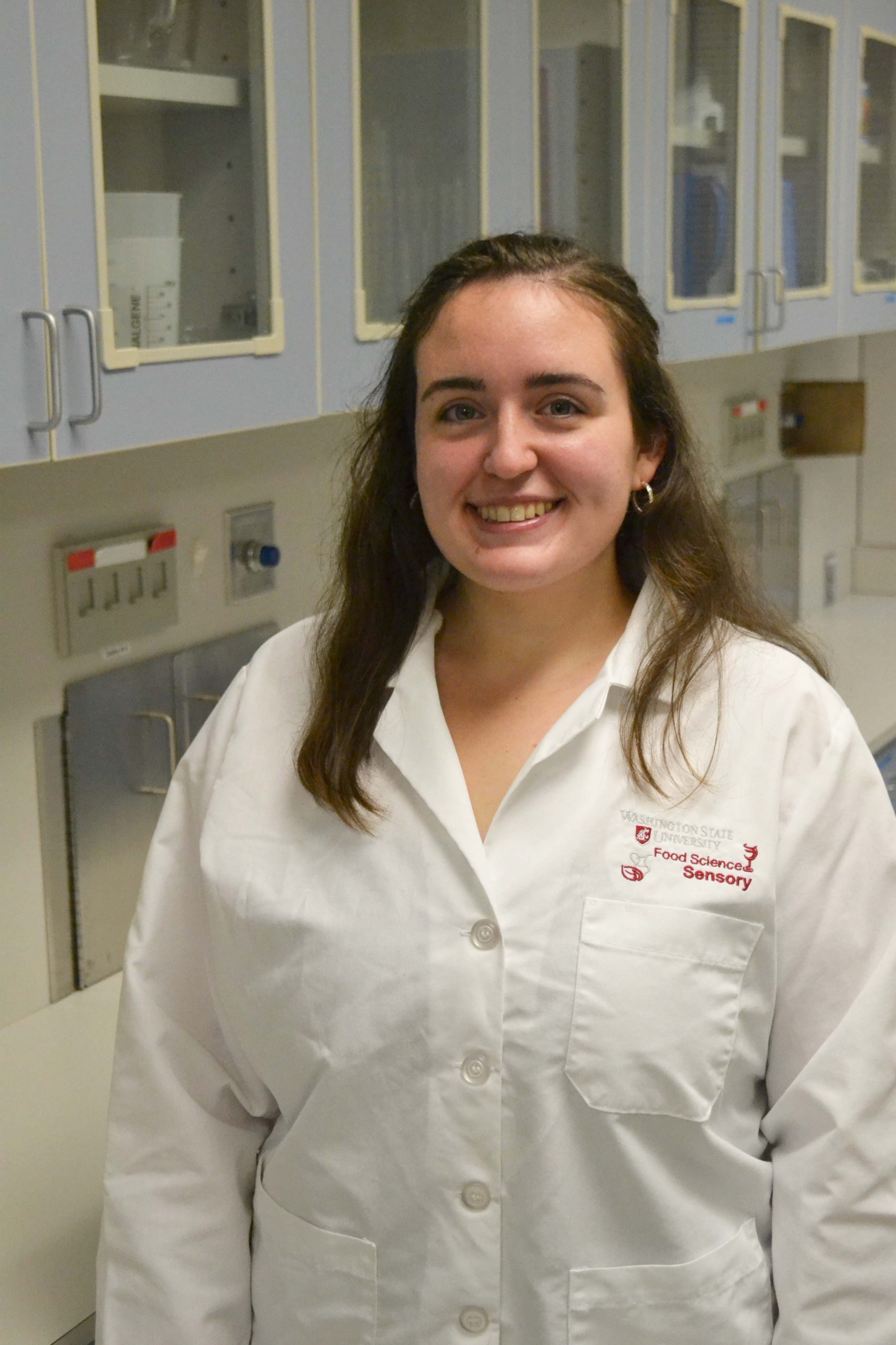 Graduate student in white lab coat