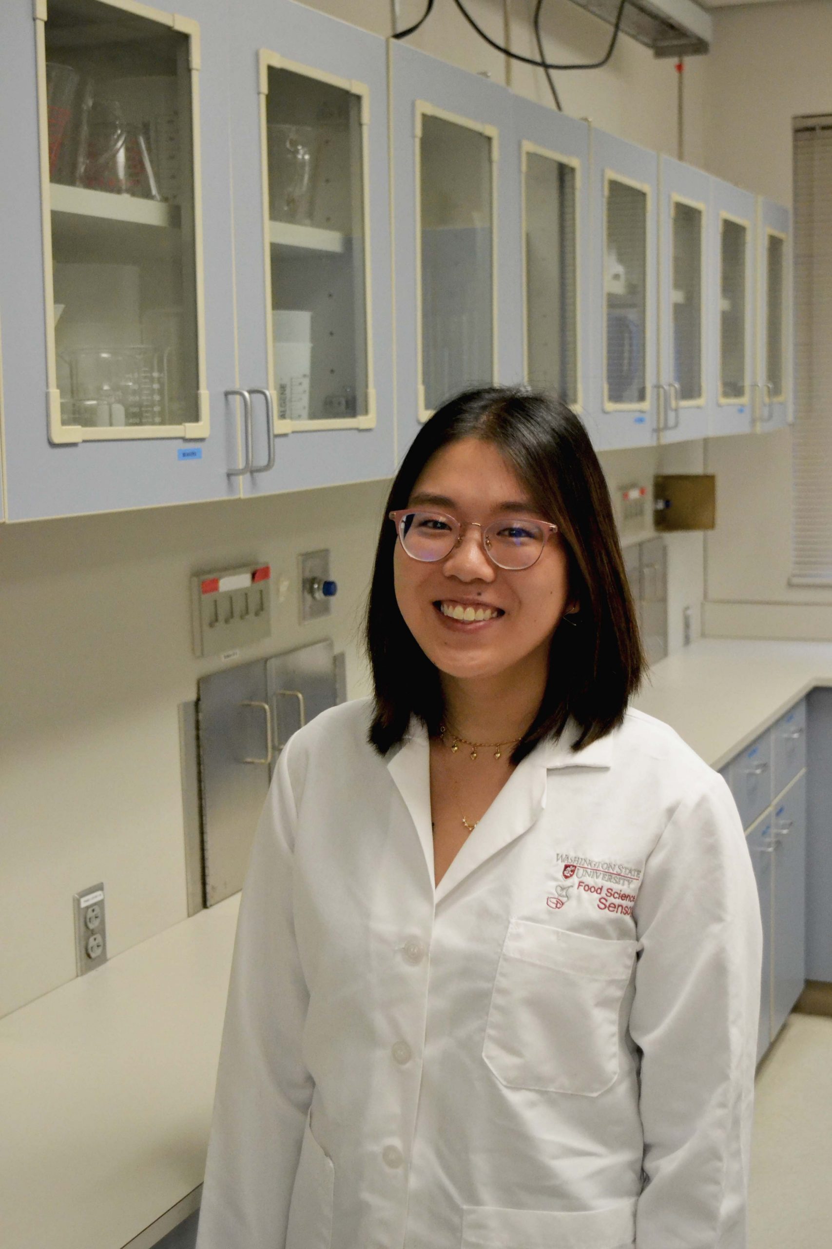 Graduate student in white lab coat