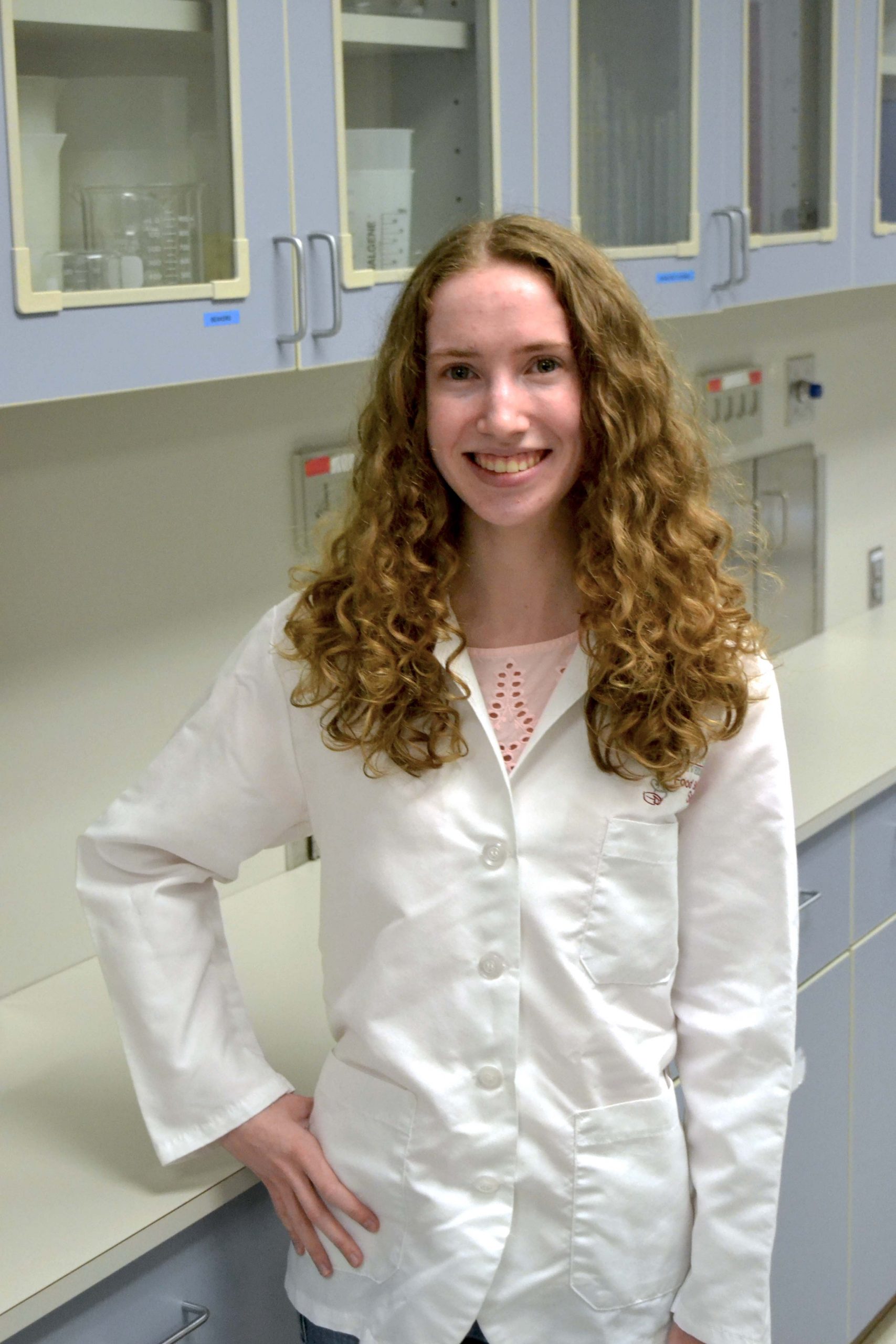 Graduate student in white lab coat