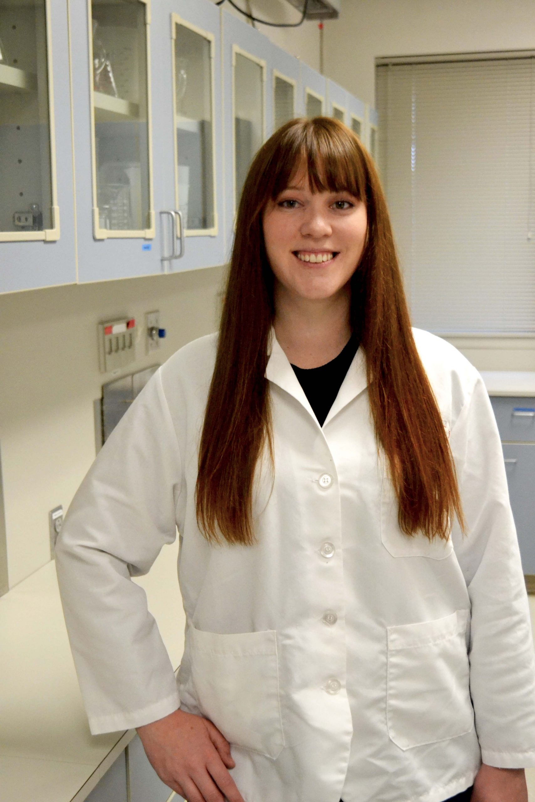 Graduate student in white lab coat