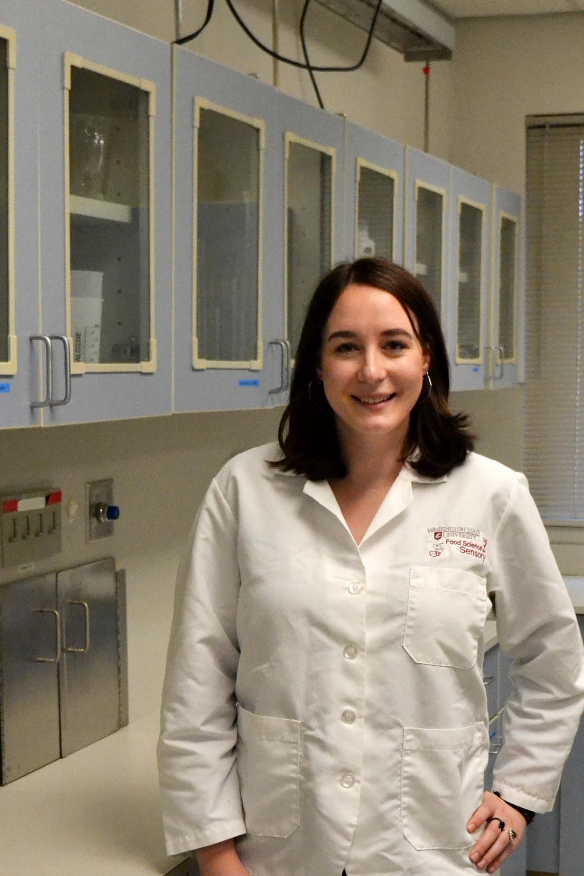 Graduate student in white lab coat