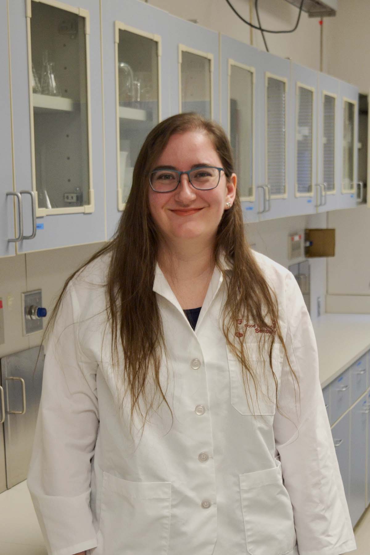 Post-doctoral researcher in white lab coat