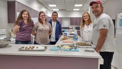 SFS students by their products in the SFS kitchen.