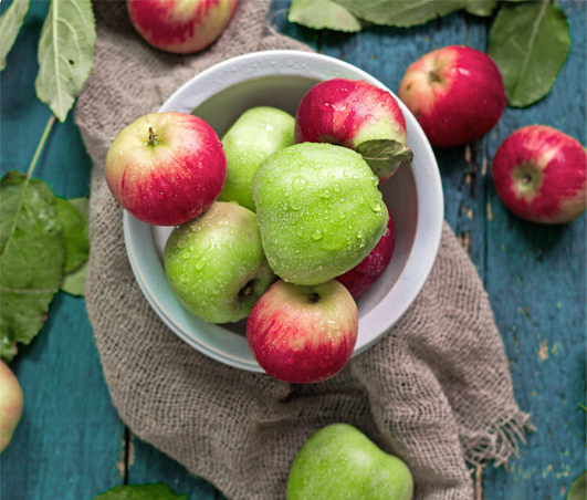 Bowl filled with green and red apples