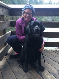 Maggie Grate with a black Labrador.