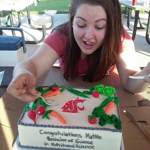 Mattie Sobotka holding a fork ready to eat a cake.