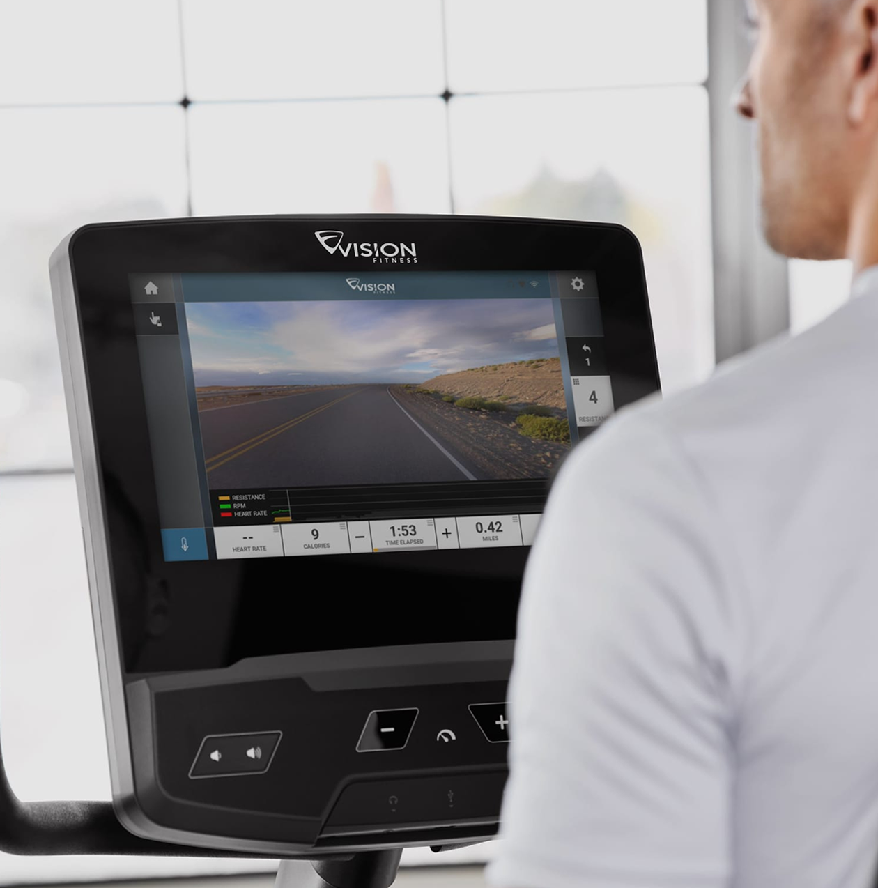 A person in a grey workout shirt using the Virtual Active app to workout in exotic locations.