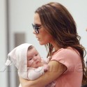 Victoria Beckham Carries Harper In NYC
