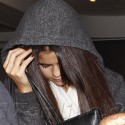 Selena Gomez Tries To Hide While Cruising Through LAX