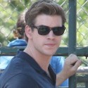 Liam Hemsworth Shows Off His Guns On Set