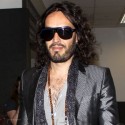 Russell Brand Looks Smug As He Lands In LAX