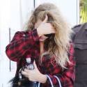 Khloe Shows Off Her Banged Up Legs In Plaid Shirt Dress