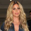 Kim Zolciak Looks Flawless In A Denim Jumpsuit For Her Flight