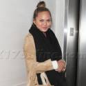 Chrissy Teigen Covers Her Baby Bump In A Chic Coat At LAX