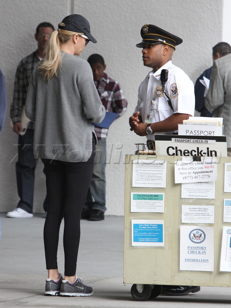 Charlize Theron passport blonde sunglasses tights 