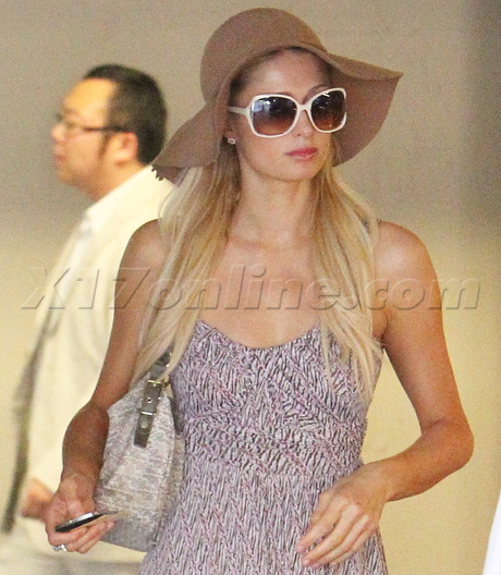 Paris Hilton hat sunglasses dress heels car Ferrari 