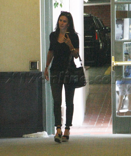 Courteney Cox jeans purse medical building