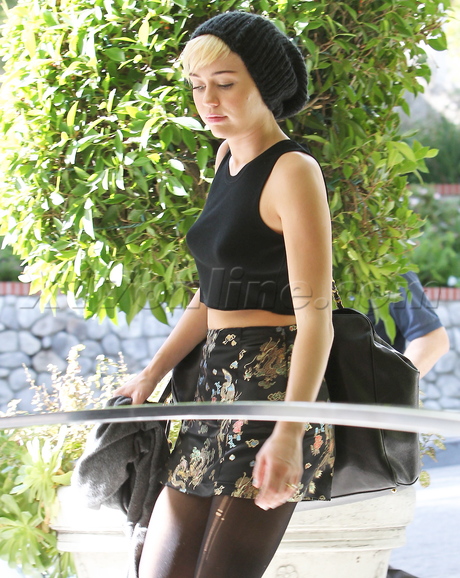 Miley Cyrus car shots porsche midriff hat silk skirt boots doc maritns 