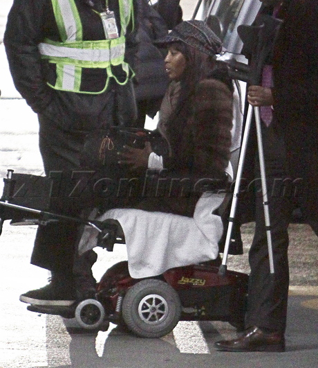 Naomi Campbell injured hat wheelchair crutches 