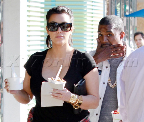 Kanye West pregnant kim kardashian reality tv boobs cleavage sunglasses leather pants plaid shirt boots pinkberry 