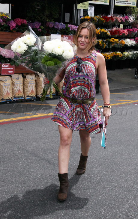 Hilary Duff  silk dress boots belted dress bus flowers 
