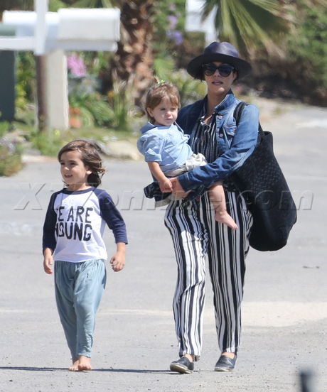 Kourtney Kardashian hat sunglasses penelope mason striped pants jean jacket