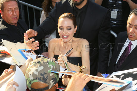 Angelina Jolie and Brad Pitt Premiere Maleficent black gown suit